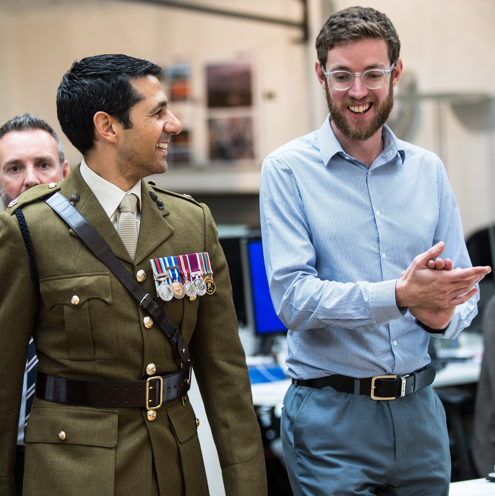 Architect and decorated serviceman engaged in friendly conversation